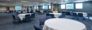 an example of a large sized meeting room set up with round tables at Quest conference center